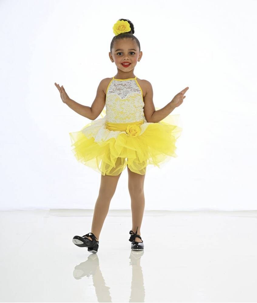 A dancer in yellow costume and tap shoes